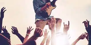 Concert attendees with various wristbands, symbolizing unity and shared music passion